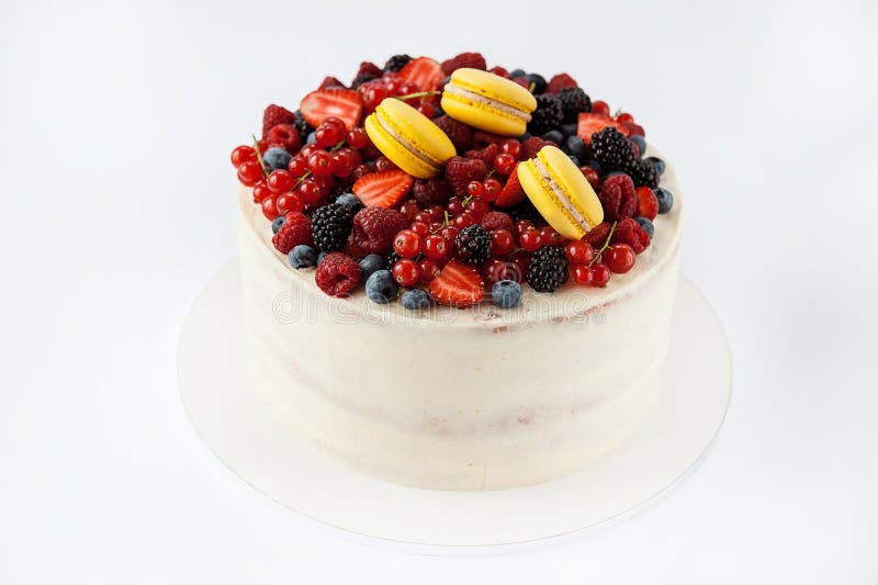 White cake with fruits and makarons. Beautiful white cake with fruits and makarons stock photo White cake with fruits and makarons. Beautiful white cake with fruits and makarons stock photo
