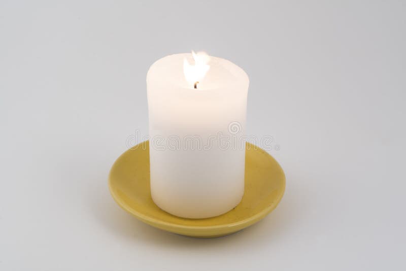 A white candle lit stock photo. Image of flame, object 103983650