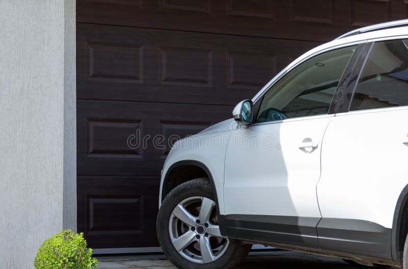 White car in front of modern house