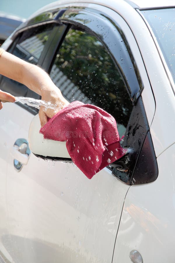 White Car Washing Windshield Wiper with Water Hose. Stock Photo Image