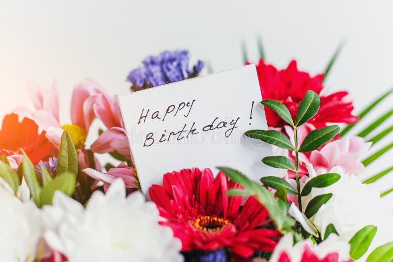 White card for a bouquet with the inscription happy birthday in a beautiful bouquet of flowers