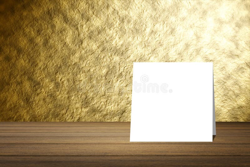 White card put on wooden desk or wooden floor on blurred abstract gold wall texture background.use for present your product.