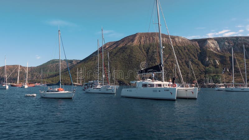 White catamarans and sailing yachts near seashore of Mediterranean sea. Lipari Islands, Sicily, Italy