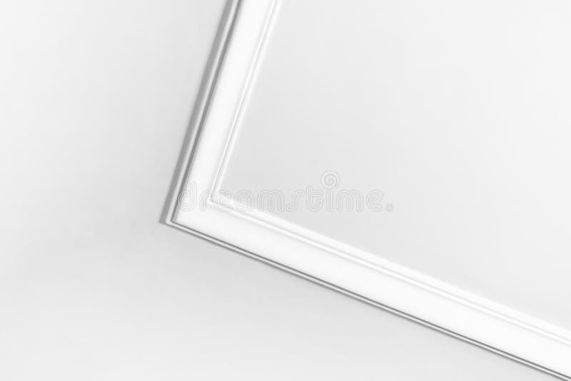 White ceiling corner featuring minimalist design with detailed molding stock image