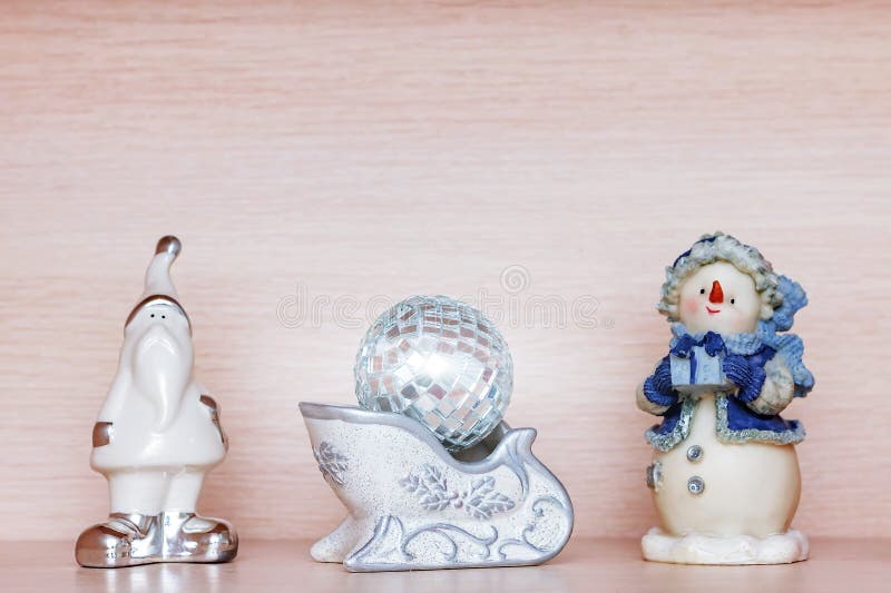 White ceramic figurine of santa claus, snowman in blue clothes and small disco xmas ball, copy space royalty free stock photos White ceramic figurine of santa claus, snowman in blue clothes and small disco xmas ball, copy space royalty free stock photos