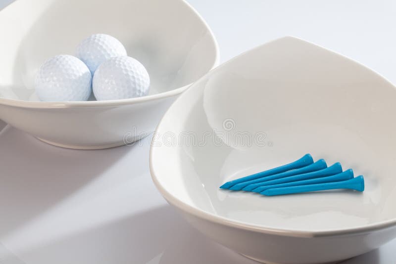 White Ceramics Bowls and Golf Balls Stock Image Image of objects