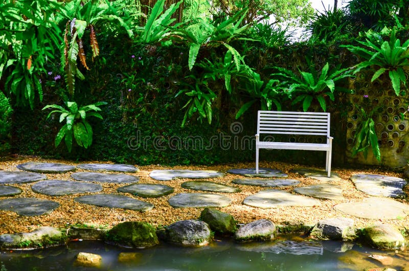 White chair on Granite floor in the garden stock photo White chair on Granite floor in the garden stock photo