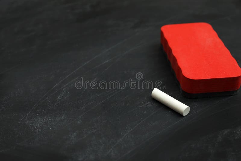 White Chalk and Duster on Black Board, Space for Text Stock Image