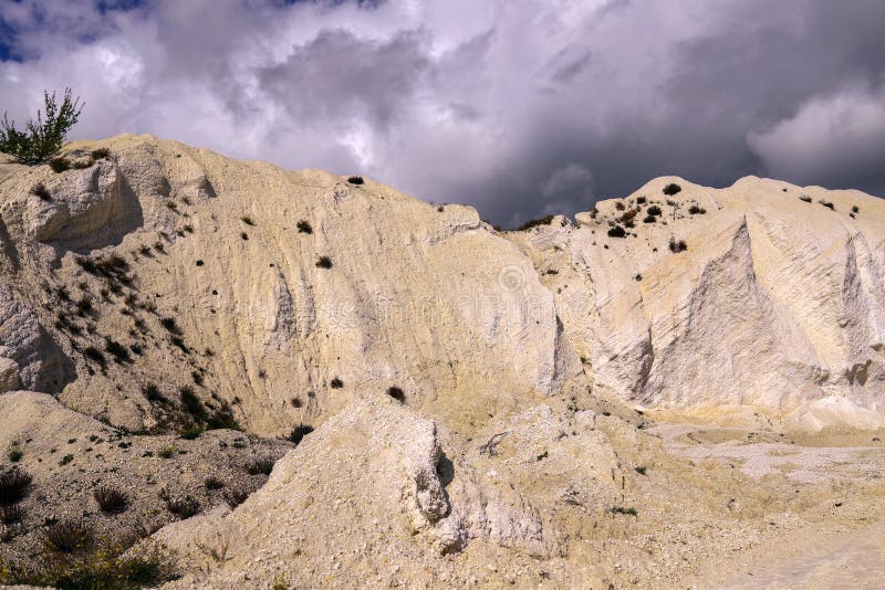 White Chalk Mountain, Quarry Against the Dark Stormy Sky Stock Photo