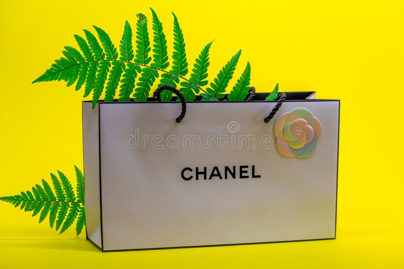 A Beautiful Flowers on a Chanel Paper Bag · Free Stock Photo
