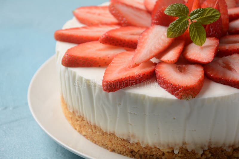 White cheese cake with strawberries garnished with mint. Sweet dessert