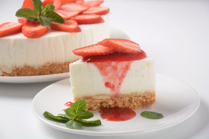 White cheese cake with strawberries garnished with mint. Sweet dessert