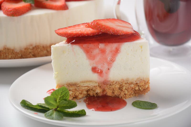 White cheese cake with strawberries garnished with mint. Sweet dessert