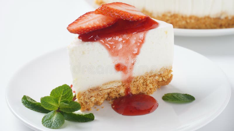 White cheese cake with strawberries garnished with mint. Sweet dessert