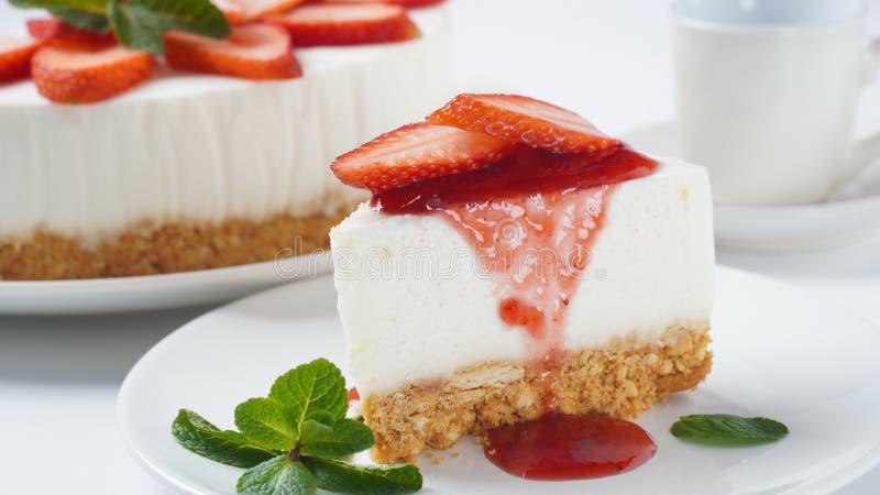 White cheese cake with strawberries garnished with mint. Sweet dessert