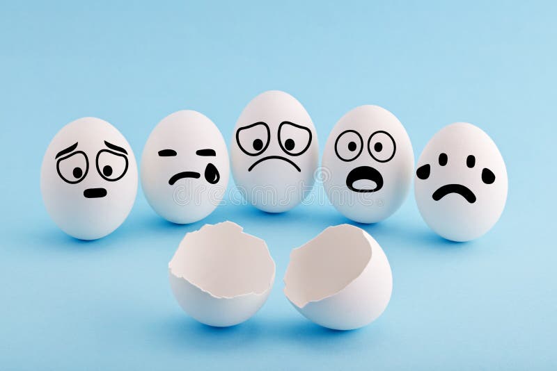 White chicken eggs with faces gathered around a broken egg shell and mourning with sad and shocked facial expressions. Concept of grief, loss or accident