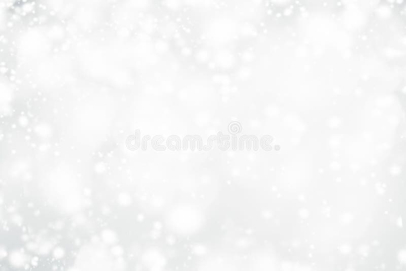 White Christmas abstract bokeh background with snowflake and silver glittering bokeh stars. Festive Glowing blurred lights.