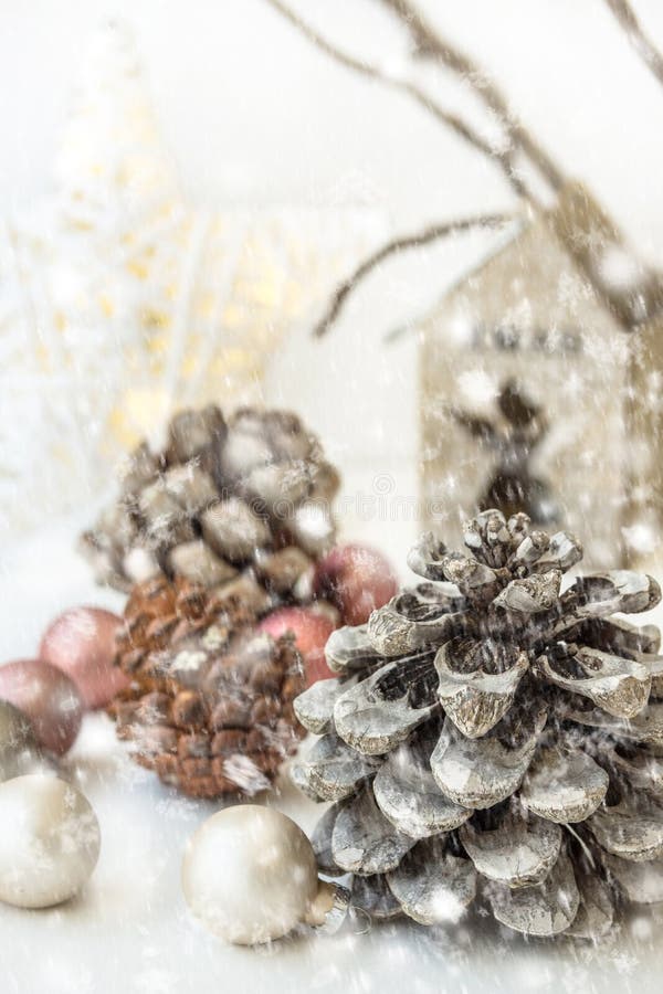 White Christmas decoration composition, pine cones, scattered baubles, shiny star, wooden candle holder, dry tree branches. Snow. royalty free stock images White Christmas decoration composition, pine cones, scattered baubles, shiny star, wooden candle holder, dry tree branches. Snow. royalty free stock images