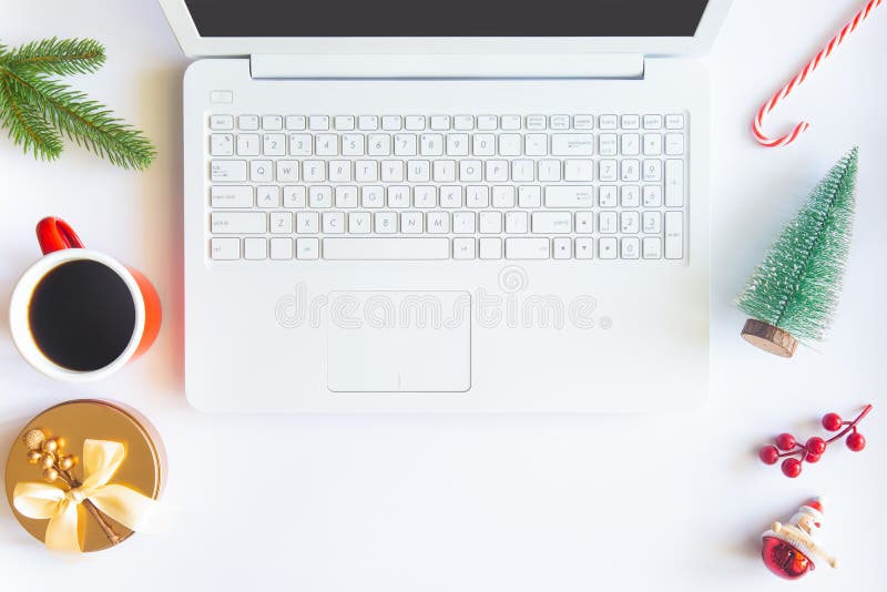 White Christmas, desk office with laptop, decoration and work supplies with cup of coffee. Top view with copy space for input the