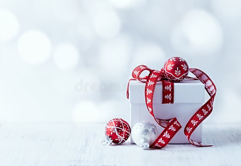 White Christmas gift with red ribbon