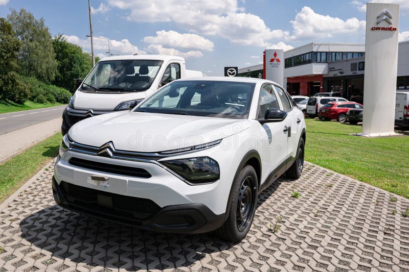 White Citroe C4 crossover car in front of dealership building prepared for test drive and to be sold