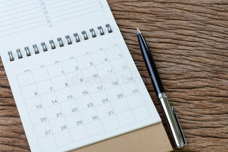 White clean calendar with pen on wooden table background using for business reminder, travel schedule or project planning concept stock images White clean calendar with pen on wooden table background using for business reminder, travel schedule or project planning concept stock images