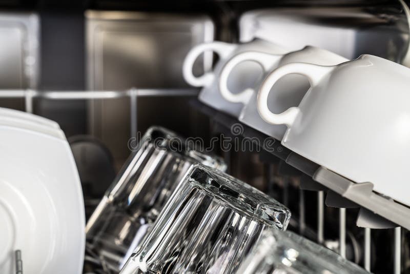 White clean cups in dishwasher royalty free stock photo