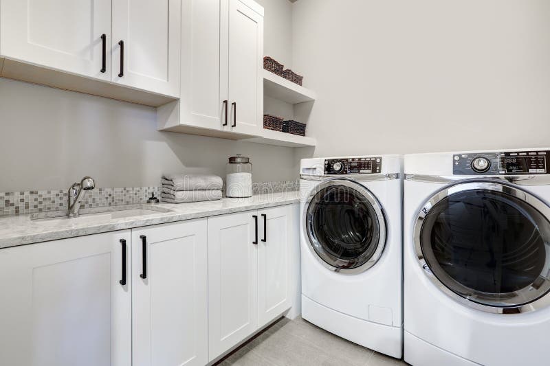 White clean modern laundry room with washer and dryer
