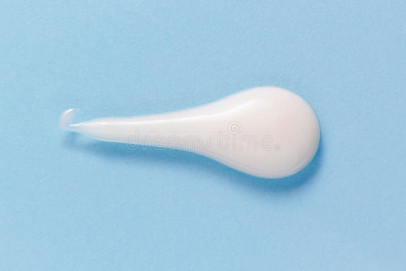 White cleansing foam gel drop on pastel blue. Hygiene, skincare product creamy texture royalty free stock photos