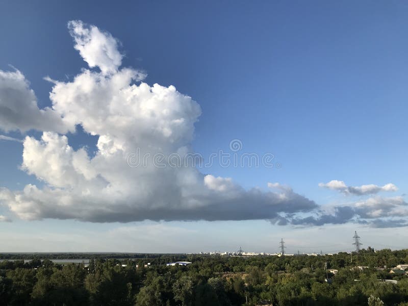 White cloud in the sunset sky over the park in Ukraine