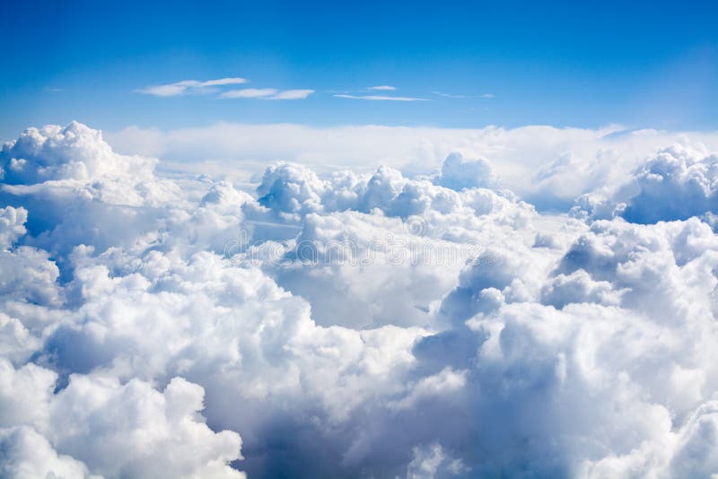 White clouds on blue sky background close up, cumulus clouds high in azure skies, beautiful aerial cloudscape view from above