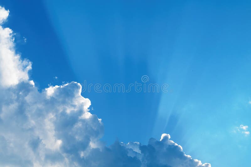 White Clouds with Shadows Cast by the Sun through the Haze on Blue Sky