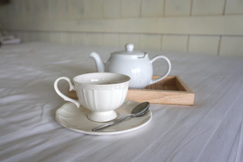 White Color Ceramic Coffee Cup with White Color Teapot on Timber Trey