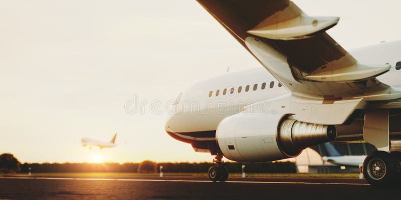 White commercial airplane standing on the airport runway at sunset. Passenger airplane is taking off. stock image White commercial airplane standing on the airport runway at sunset. Passenger airplane is taking off. stock image