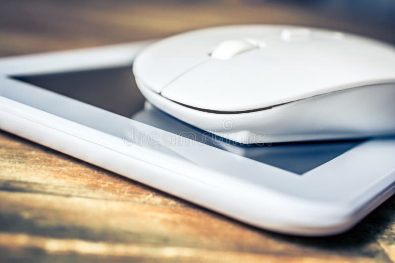 White Tablet And Grey Pencil Lying Next To A White Keyboard On Wooden