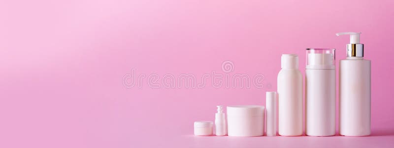 White cosmetic tubes on pink background with copy space. Skin care, body treatment, beauty concept. Banner