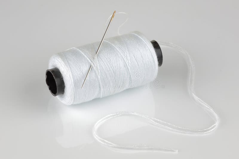White Cotton Reel and Needle with Reflection Stock Image - Image of ...