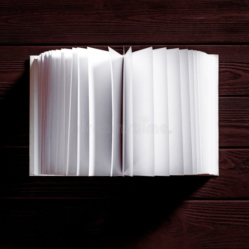 The white-cover book is on a textured wooden table royalty free stock photos The white-cover book is on a textured wooden table royalty free stock photos