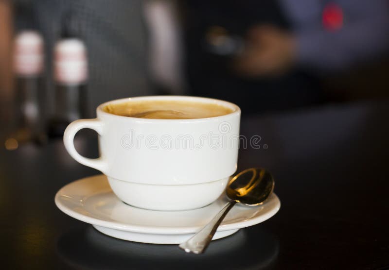 The White Cup of Black Espresso Coffee at Bar Counter in Cafe Stock