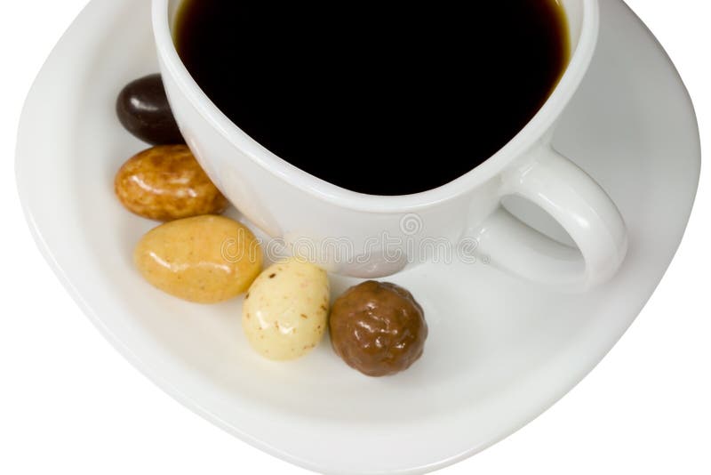 White cup of coffee with candies