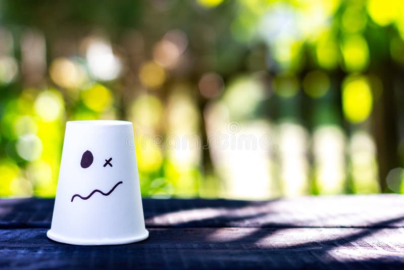 White cup with drawn emotion of surprise, confusion