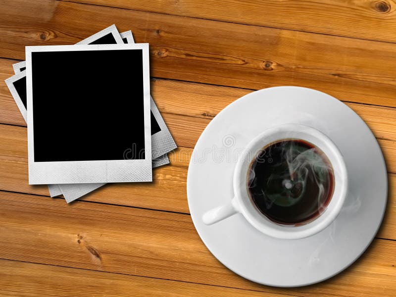 White cup of hot coffe and photo frame