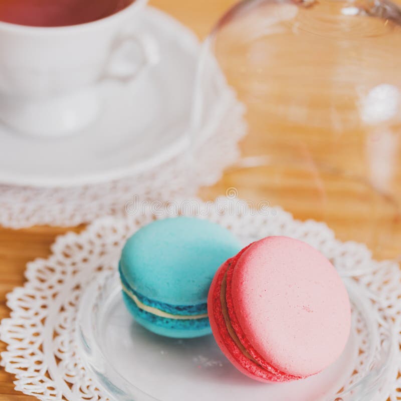 White cup of hot tea, macaroni and fresh shortbread cookies . Mint and strawberry taste. On a napkin. Congratulations on Valentine royalty free stock images White cup of hot tea, macaroni and fresh shortbread cookies . Mint and strawberry taste. On a napkin. Congratulations on Valentine royalty free stock images