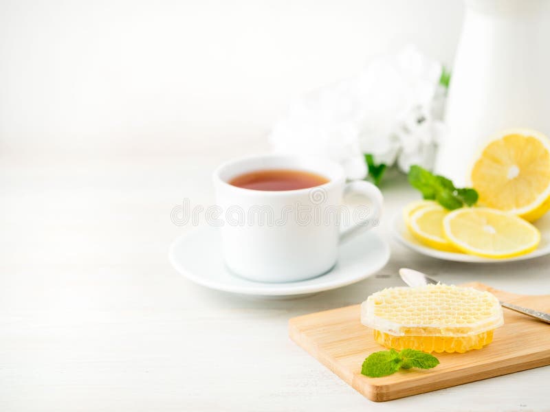 White Cup of Tea, Honey, Lemon on White Background. Folk