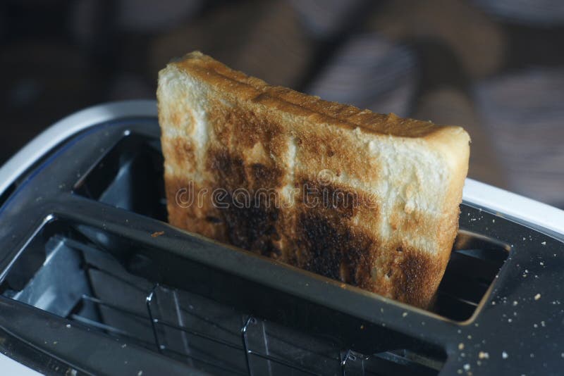 White Dirty Toaster and Burned Toast (selective Focus,dark Tone) Stock