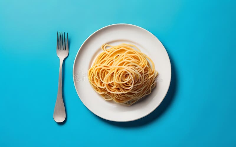 On a White Dish with a Blue Background, Spaghetti Noodles is Served