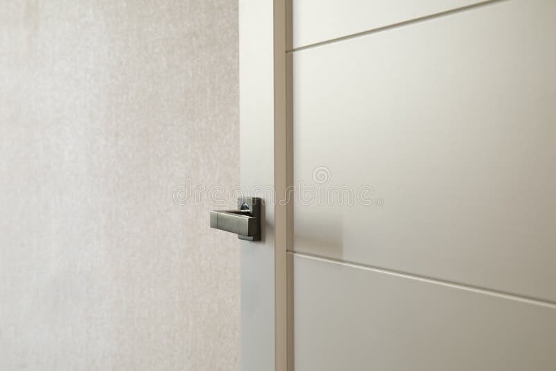 White door with black handle open to the room royalty free stock image