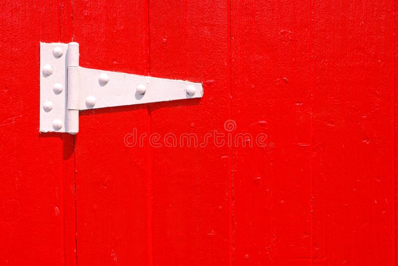 Painted white door hinge on red painted door