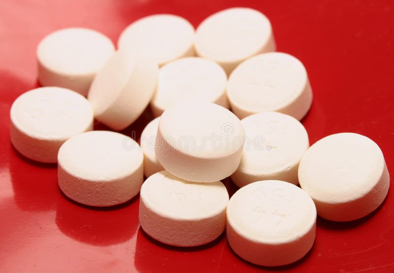 White Drug Pills on Shiney Red Background