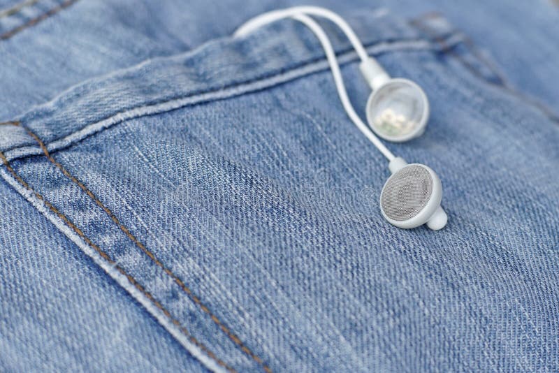 White earbuds in back pocket old jeans